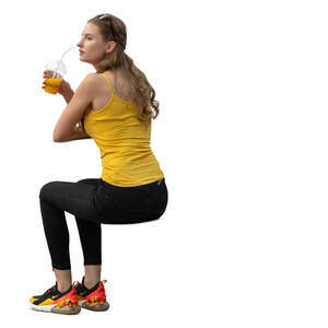 woman sitting and drinking orange juice