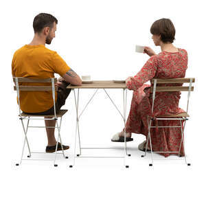 two cut out people sitting in a coffeeshop seen from back angle