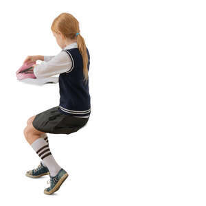 cut out schoolgirl sitting at a desk and writing