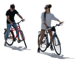 two cut out backlit people with bikes standing ready to start riding 