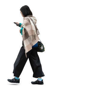 asian woman with a big scarf walking while reading her phone