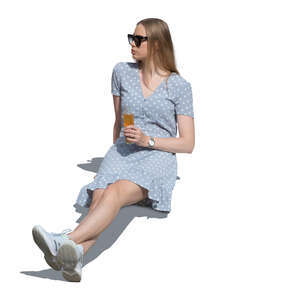 woman sitting outside in summer and drinking lemonade