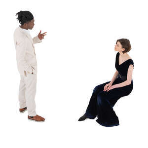 top angle view of a man in a white suit talking to a woman in black sitting