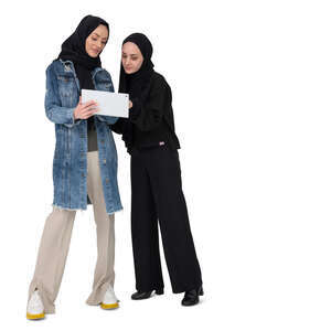 two muslim women wearing hijabs looking at a tablet together