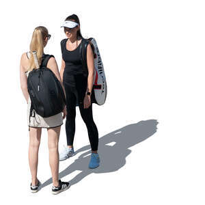 two women with tennis equipment standing and talking seen from higher angle