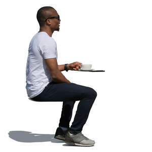 black man sitting in a cafe in summer