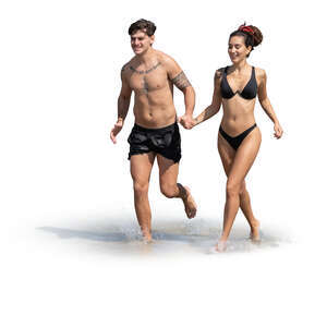 couple running happily along the beach