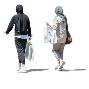 two muslim women with shopping bags walking 