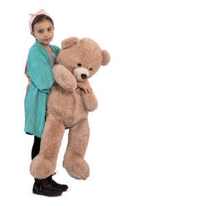 little girl with a big teddy bear standing