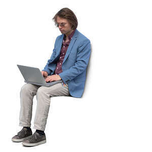 young man with a laptop sitting and working