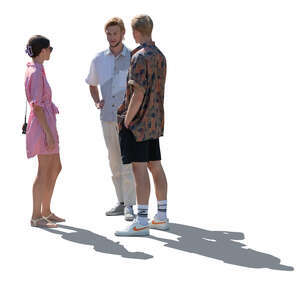 backlit group of three young people in summer standing and talking