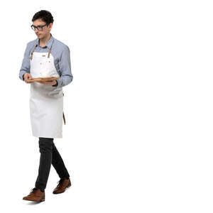 young male waiter with a white apron walking