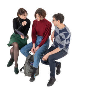 cut out group of three friends sitting and talking seen from above