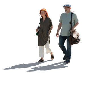 backlit elderly couple walking in summer
