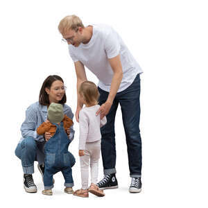 family with two little kids standing in the street