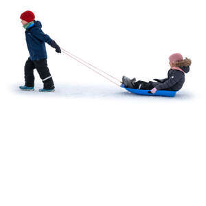 little boy pulling a sledge with a little girl sitting on it