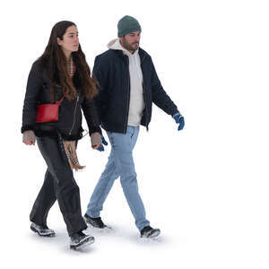 two cut out people walking on a snowy street in winter