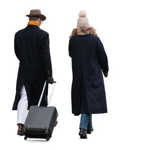 two people walking with a suitcase in winter