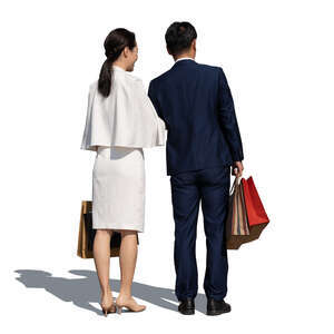 asian couple with shopping bags standing in front of the shop window