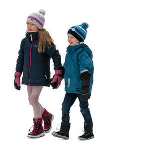 two kids walking happily hand in hand in winter