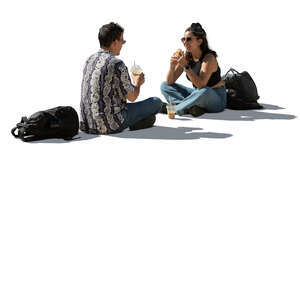 backlit sitting couple eating lunch on the street