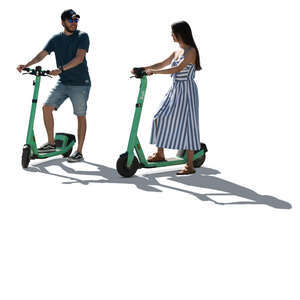 two backlit people with electric scooters standing