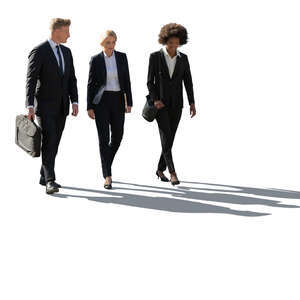 backlit group of office workers walking