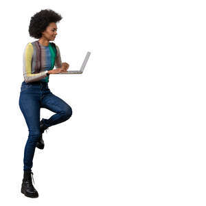 woman sitting at a counter high table on a barstool with a laptop