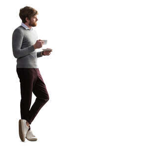 man standing by the window and drinking coffee