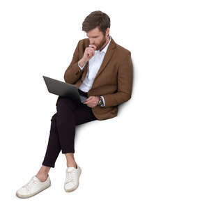 man with a laptop sitting on a sofa seen from a above