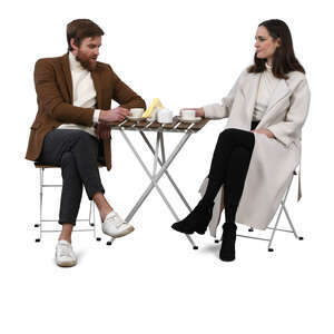 man and woman sitting in a cafe and talking