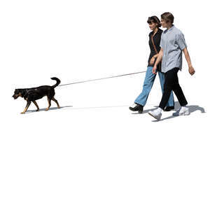 teenage couple with a dog walking