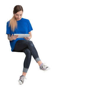 woman sitting and reading a tablet