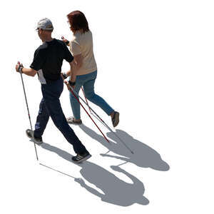 backlit elderly couple nordic walking