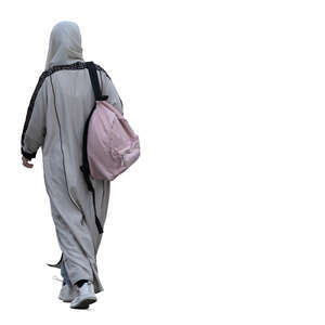 muslim woman with a backpack walking