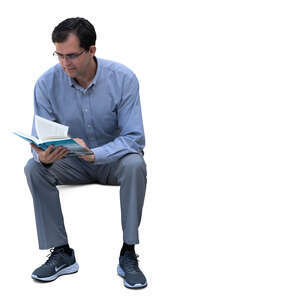 man sitting and reading a book