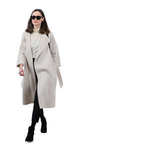 woman in a white overcoat walking