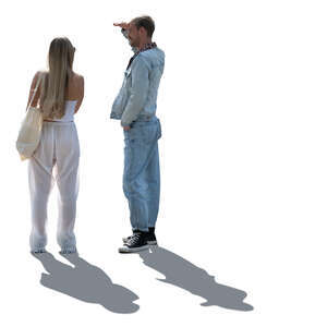 two backlit people standing and looking into distance