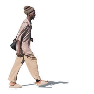 black man in light brown outfit walking