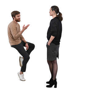 man sitting on a table and talking to a woman