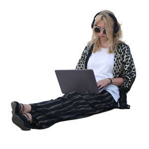 woman with a laptop sitting on the ground