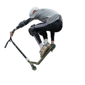 boy with a scooter doing tricks in skatepark