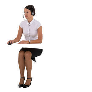 female offoce worker with a headset working with computer