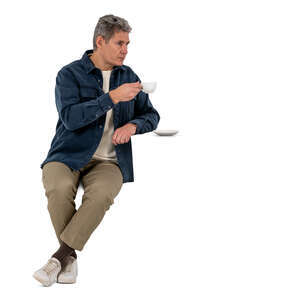 older gentleman sitting and drinking coffee