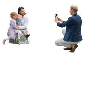 man taking a picture of his wife and kids