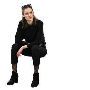 woman in a black outfit sitting