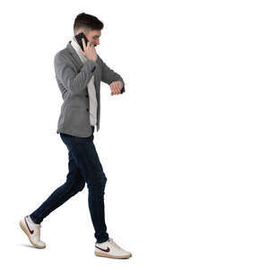 man walking and talking on a phone and looking at his watch