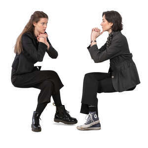 two women sitting and talking