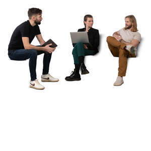 three people sitting and talking