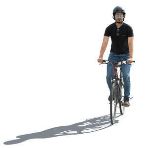 backlit man with a helmet riding a bike